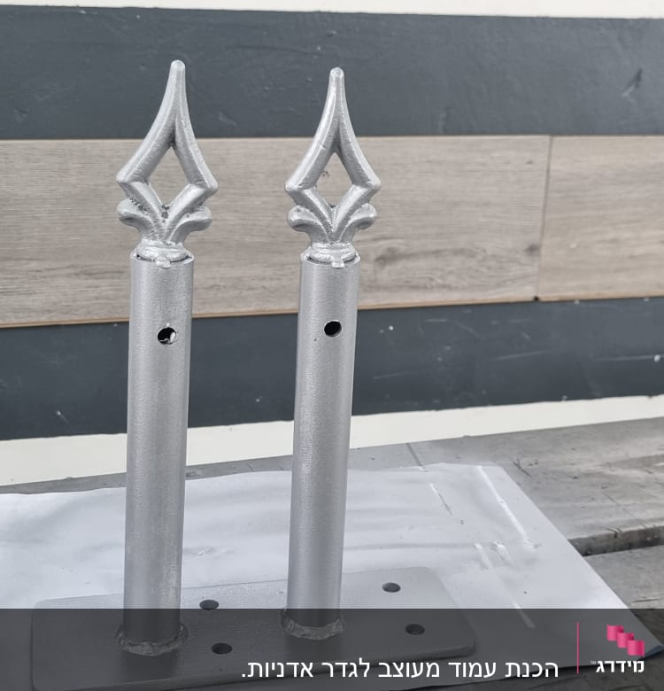 שני עמודי מתכת עם קישוטים על בסיס מלבני